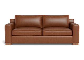  Burnside sofa in caramel leather with deep seat, wide track arms and block legs in walnut. 